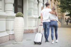 couple-with-suitcase-walking